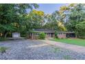 Well-maintained brick home featuring a long driveway, detached garage, and ample parking space at 310 Samaritan Dr, Cumming, GA 30040