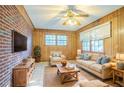 Inviting living room featuring a brick accent wall, comfortable seating, and plenty of natural light at 310 Samaritan Dr, Cumming, GA 30040