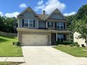 Beautiful two-story home with a two-car garage, and landscaped front yard and the perfect amount of greenery at 239 Lenore Ct, Hiram, GA 30141