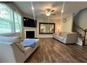 Spacious living room with a cozy fireplace, large mirror, and hardwood floors, creating an inviting atmosphere at 239 Lenore Ct, Hiram, GA 30141