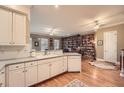 Bright kitchen open to library featuring white cabinets, hardwood floors, and modern appliances at 397 4Th Ne St, Atlanta, GA 30308