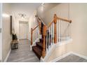 Inviting entryway with hardwood floors, staircase with wooden handrail and neutral color palette at 734 Celeste Sw Ln # 84, Atlanta, GA 30331