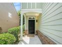 Inviting front porch with a dark door, brick accents, and well-maintained landscaping at 2100 Lily Valley Dr, Lawrenceville, GA 30045