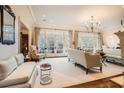 Bright living room filled with natural light, featuring neutral decor, a fireplace, and French doors to the outside at 4340 Garmon Rd Nw, Atlanta, GA 30327