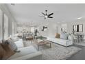 Bright, open-concept living room with modern furnishings and seamless flow to the kitchen at 399 Tillman Pass, Woodstock, GA 30188