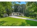 View of the home from the driveway showcasing its backyard storage building at 4291 Lamar Street St, Decatur, GA 30035