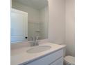 Bathroom featuring a modern vanity, sleek fixtures, and a large mirror and toilet at 1915 Deco Dr, Kennesaw, GA 30144