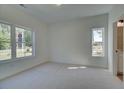 Bright bedroom has carpet, two windows, and white walls allowing for various décor options at 1915 Deco Dr, Kennesaw, GA 30144