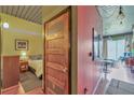 Hallway featuring a wooden door that leads to the bedroom and stylish light fixtures at 620 Glen Iris Ne Dr # 206, Atlanta, GA 30308
