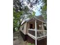 Exterior shot of home with a porch area and steps leading to the front door at 1566 Avon Sw Ave, Atlanta, GA 30311