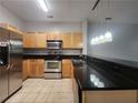 Kitchen with stainless steel appliances, black countertops, and pendant lighting at 870 Mayson Turner Nw Rd # 1238, Atlanta, GA 30314