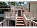 Inviting front deck with railing and steps leading to the front door of this charming two-story home at 3038 Skidaway Ct, Stone Mountain, GA 30087