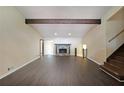 Spacious living room featuring hardwood floors, stone fireplace, high ceilings, and exposed beam at 3038 Skidaway Ct, Stone Mountain, GA 30087