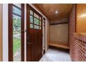 Welcoming entryway with a stylish brick wall, wooden bench and coatrack, and tiled floors at 44 Aberdeen St, Atlanta, GA 30307