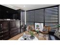 Living room showing dark wood built-ins, striped shades, and modern furnishings at 1280 W Peachtree W St, Atlanta, GA 30309