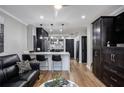 Open-concept living area featuring a black leather sofa and modern decor at 1280 W Peachtree W St, Atlanta, GA 30309