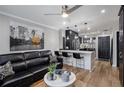 Open-concept living area with a breakfast bar and sleek black furnishings at 1280 W Peachtree W St, Atlanta, GA 30309