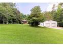 Wide shot of a large yard with a house and outbuilding at 5670 Lanny Dr, Powder Springs, GA 30127