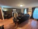 Warm living room featuring a decorative fireplace, plush seating, and natural light from the windows at 1005 Timbervale Ln, Lithonia, GA 30058