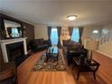 Inviting living room with hardwood floors, a fireplace, comfortable seating, and tasteful decor at 1005 Timbervale Ln, Lithonia, GA 30058