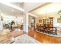 Spacious living room with hardwood floors, neutral paint, elegant furnishings, and an abundance of natural light at 1432 Arbor Bluff Ct, Lawrenceville, GA 30045