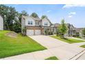 Attractive two-story home with stone accents, gray siding, well-kept lawn, and a spacious driveway at 5394 Pebblebrook Se Ln, Mableton, GA 30126
