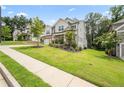 Beautiful home with lush green lawn, stone accents, gray siding, and well-maintained landscaping at 5394 Pebblebrook Se Ln, Mableton, GA 30126