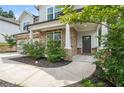 Inviting front entrance with stone pillars, a gray front door, and manicured landscaping at 5394 Pebblebrook Se Ln, Mableton, GA 30126