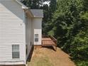 Exterior view of a home featuring a wooden deck, white siding, and lush greenery at 856 Haydens Rdg, Ellenwood, GA 30294