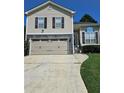 Attractive home featuring a two-car garage, gray stone accents, and a manicured front lawn at 4209 Resheemah St, Atlanta, GA 30349