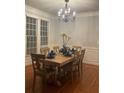 Elegant dining room featuring a wooden table with seating for eight and a chandelier overhead at 727 Pear Grove Pl, Marietta, GA 30066