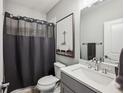 Stylish bathroom featuring modern fixtures, a shower curtain, and neutral tones at 2447 Figaro Dr, Atlanta, GA 30339