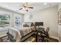 Comfortable bedroom featuring hardwood floors, a ceiling fan, and natural light at 2447 Figaro Dr, Atlanta, GA 30339