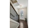 Inviting foyer with hardwood floors, staircase, and elegant lighting fixtures at 2447 Figaro Dr, Atlanta, GA 30339
