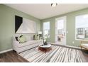 Bright living room with modern decor, green accent wall, and access to the outdoors at 2684 Brookview Nw Ln, Atlanta, GA 30318