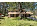 Inviting two-story home with a brick facade, lush lawn, and mature trees providing shade and curb appeal at 1542 Riderwood Ct, Decatur, GA 30033