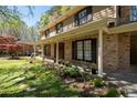 Charming brick home featuring a covered front porch and a beautifully landscaped flower bed at 1542 Riderwood Ct, Decatur, GA 30033