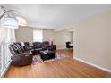 Cozy living room with a plush sectional sofa, hardwood floors, and bright natural light from large windows at 1542 Riderwood Ct, Decatur, GA 30033
