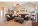 Inviting living room with vaulted ceilings, a ceiling fan, and comfortable seating with views of built-in shelves at 15 Fairwoods Ct, Covington, GA 30016