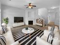 Bright living room with a fireplace, white couches, and a striped rug at 324 Stoney Hollow Rd, Canton, GA 30114