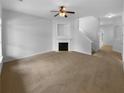 Empty living room featuring neutral colored walls, carpet and a fireplace at 324 Stoney Hollow Rd, Canton, GA 30114