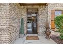 Inviting front entrance with brick facade and a charming welcome mat leading to a view of the interior at 538 Mulberry Fern Dr, Auburn, GA 30011