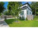Side view of the modern home displaying a lush lawn and wood fence at 833 Humphries Sw St, Atlanta, GA 30310