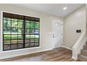 Home entryway featuring new vinyl floors, natural light, and staircase to the second floor at 340 Windsor Se Walk, Conyers, GA 30094