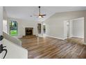 Spacious living room with beautiful vinyl floors, stone fireplace, and large windows at 340 Windsor Se Walk, Conyers, GA 30094