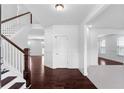 Bright entryway boasts dark hardwood floors, white trim, and an open staircase to the upper level at 1261 Palouse Hills Pl, Lawrenceville, GA 30044