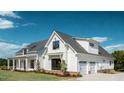New construction farmhouse with white board and batten siding, black windows, and attached two-car garage at 1290 Jack Page Ln, Canton, GA 30115