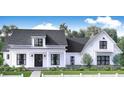 Inviting two-story farmhouse with a covered front porch, white picket fence, and beautifully manicured lawn at 1290 Jack Page Ln, Canton, GA 30115