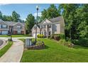 View of home's manicured lawn, brick exterior, and lush, mature landscaping at 1343 Cartwright Ln, Lawrenceville, GA 30045
