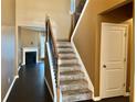 View of a carpeted staircase with dark wood floors and trim, leading to the second floor at 1854 Caswell # 56, Marietta, GA 30060